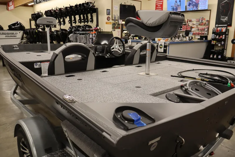 Slide: The Image of 2026 Smoker Craft Viper 175 Pro boat interior in showroom setting. - 11