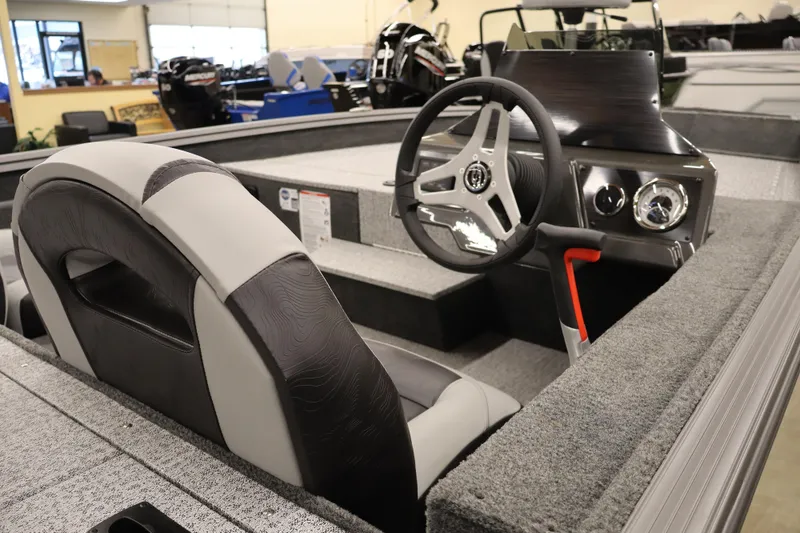 Slide: The Image of 2026 Smoker Craft Viper 175 Pro boat interior with steering wheel and dashboard. - 4