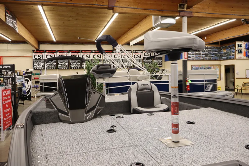 Slide: The Image of 2026 Smoker Craft Viper 175 Pro boat interior in showroom, featuring seating and equipment. - 5