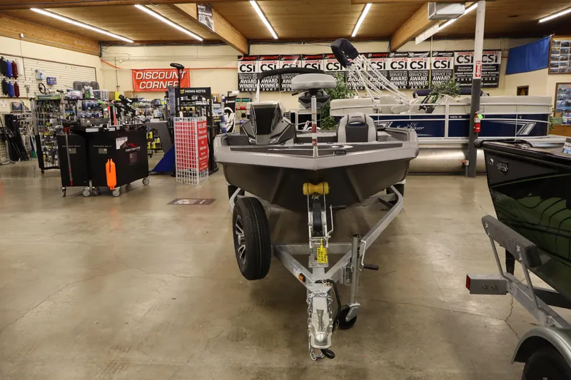 Slide: The Image of 2026 Smoker Craft Viper 175 Pro boat displayed in a showroom with accessories. - 7