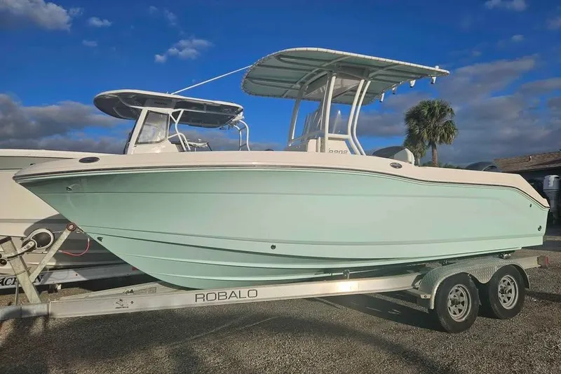 The Image of 2021 Robalo R202 Explorer boat on trailer under blue sky. - 0
