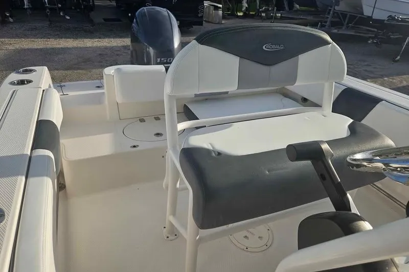 Slide: The Image of 2021 Robalo R202 Explorer boat interior with seating and steering wheel. - 11