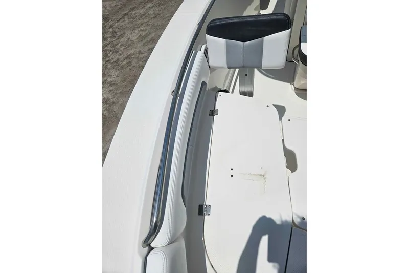 Slide: The Image of 2021 Robalo R202 Explorer boat interior with white seating and storage compartment. - 13