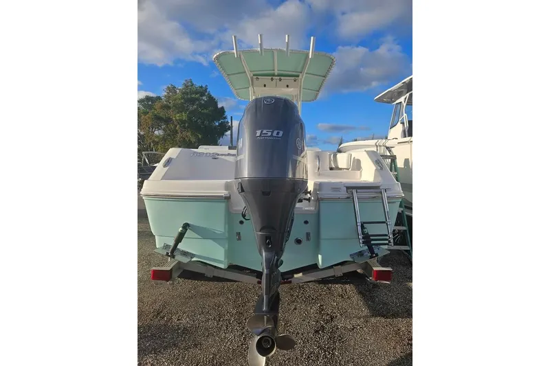 Slide: The Image of 2021 Robalo R202 Explorer boat with outboard motor, parked outdoors. - 2