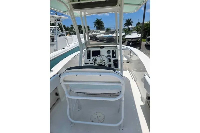 Slide: The Image of 2021 Robalo R202 Explorer boat interior with helm and seating area. - 4