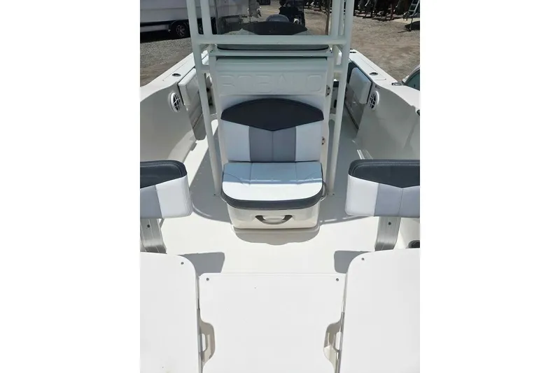 Slide: The Image of 2021 Robalo R202 Explorer boat interior with cushioned seating and storage compartments. - 6