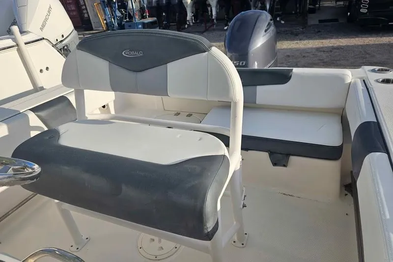 Slide: The Image of 2021 Robalo R202 Explorer boat interior with seating and engine view. - 7