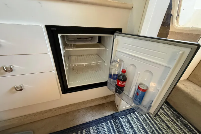 Slide: The Image of 1998 Rinker Fiesta Vee 280 boat bathroom with sink, toilet, and storage. - 20