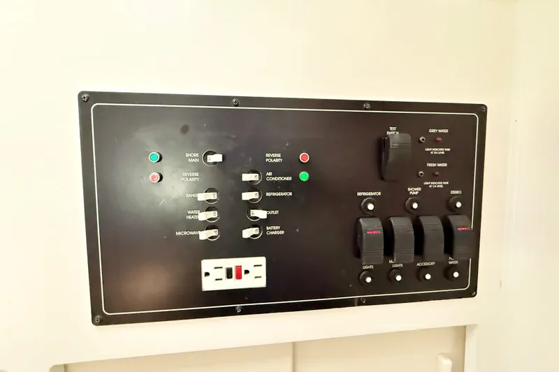 Slide: The Image of Control panel of a 1998 Rinker Fiesta Vee 280 boat with generator switch. - 22