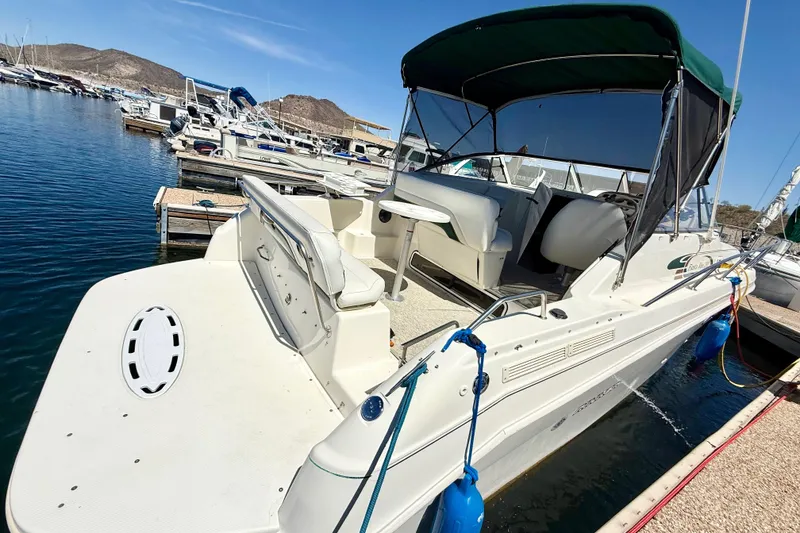 Slide: The Image of 1998 Rinker Fiesta Vee 280 docked at marina, surrounded by other boats. - 3
