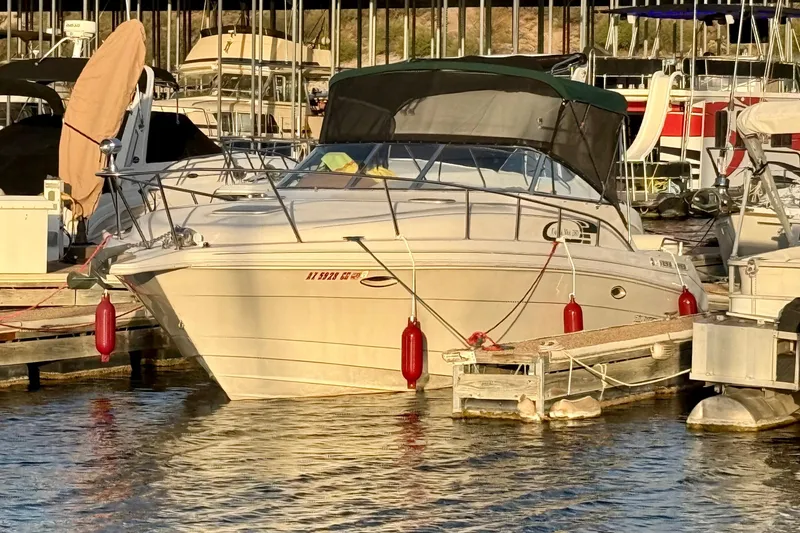 Slide: The Image of 1998 Rinker Fiesta Vee 280 docked at marina with red fenders and covered canopy. - 30