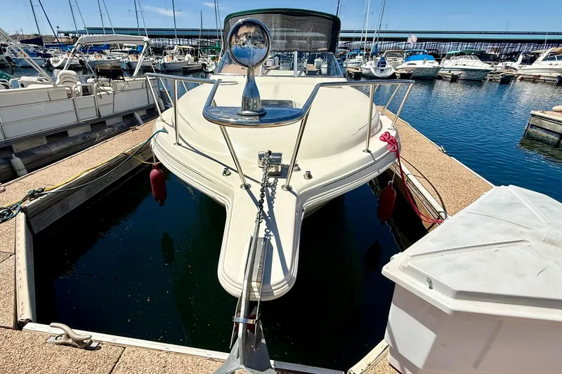 Slide: The Image of 1998 Rinker Fiesta Vee 280 docked at marina, sunny day, clear sky. - 4
