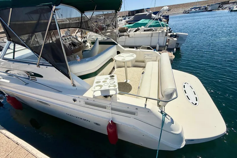 Slide: The Image of 1998 Rinker Fiesta Vee 280 boat interior with white seating and control panel. - 6