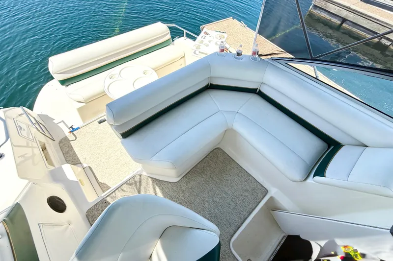 Slide: The Image of 1998 Rinker Fiesta Vee 280 boat dashboard with steering wheel and control panel. - 8