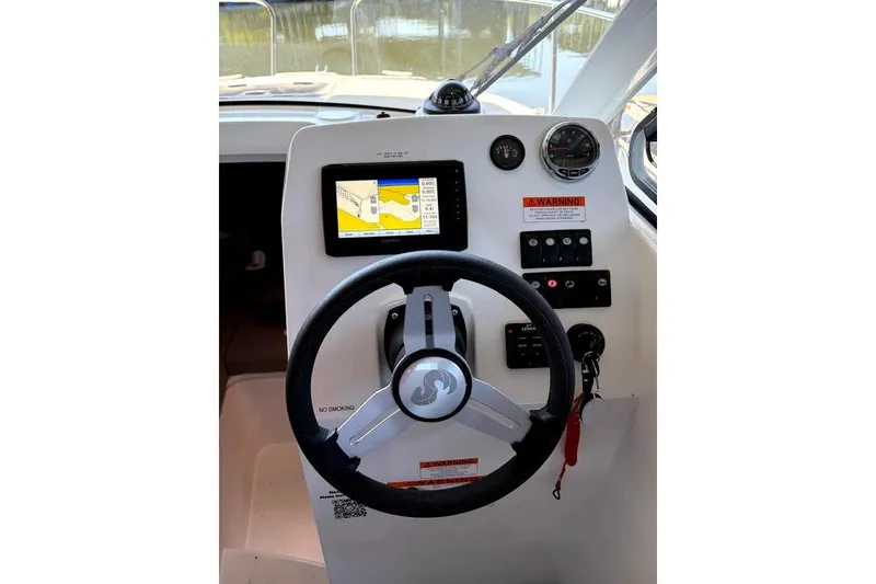 Slide: The Image of Helm of 2023 Beneteau Antares 7 with navigation display and controls. - 14