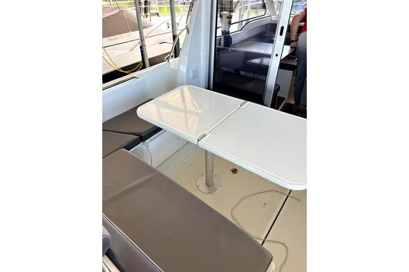 Slide: The Image of Interior view of 2023 Beneteau Antares 7, featuring a sleek dining area with cushioned seating. - 15