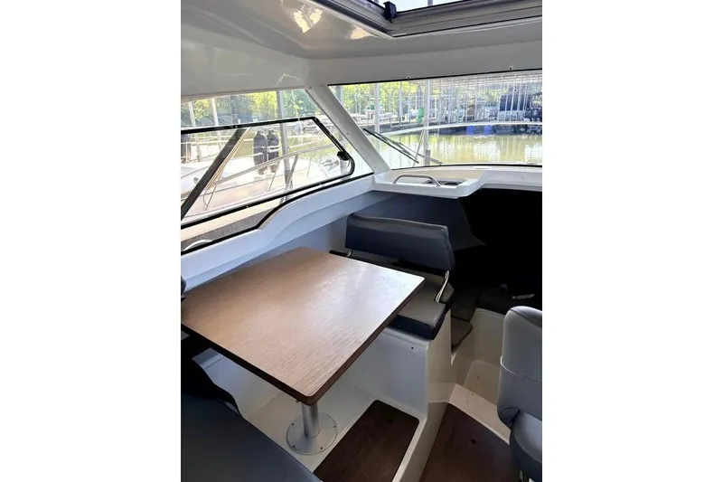 Slide: The Image of Interior of 2023 Beneteau Antares 7 boat with seating and table. - 18