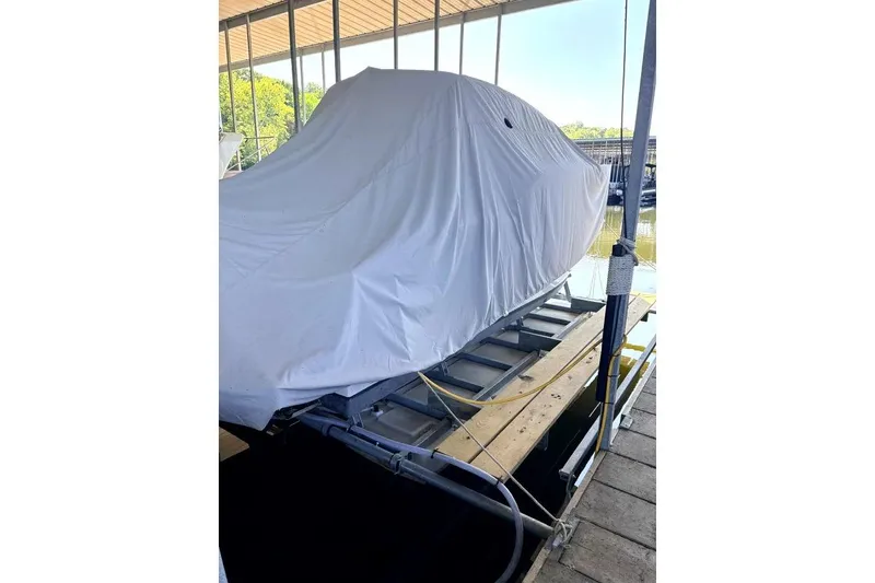 Slide: The Image of 2023 Beneteau Antares 7 covered and docked at a marina. - 20