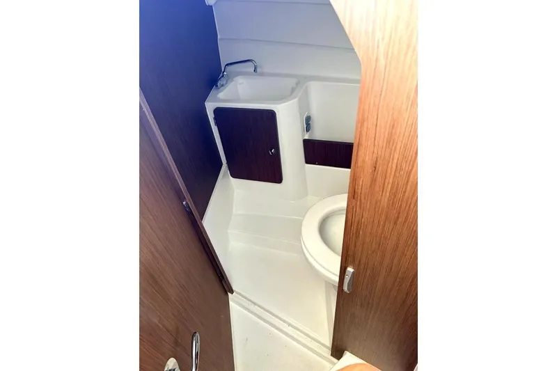 Slide: The Image of Compact bathroom in 2023 Beneteau Antares 7 boat, featuring wooden accents and modern fixtures. - 21