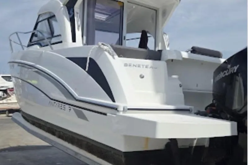 Slide: The Image of 2023 Beneteau Antares 7 boat with Mercury engine, docked on a sunny day. - 3
