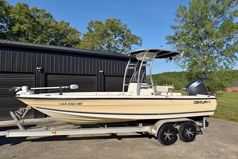 The Image of 2007 Century 2102 Inshore boat on trailer, parked outdoors near black building. - 0