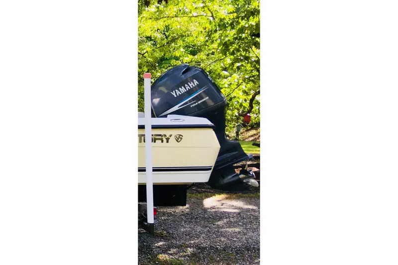 Slide: The Image of 2007 Century 2102 Inshore boat with Yamaha outboard motor, parked outdoors. - 17