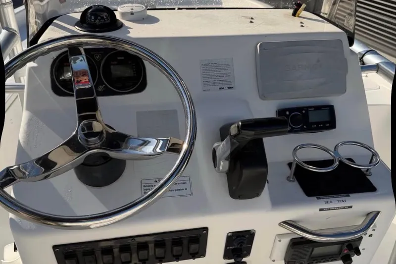 Slide: The Image of Steering console of a 2007 Century 2102 Inshore boat with controls and gauges. - 2