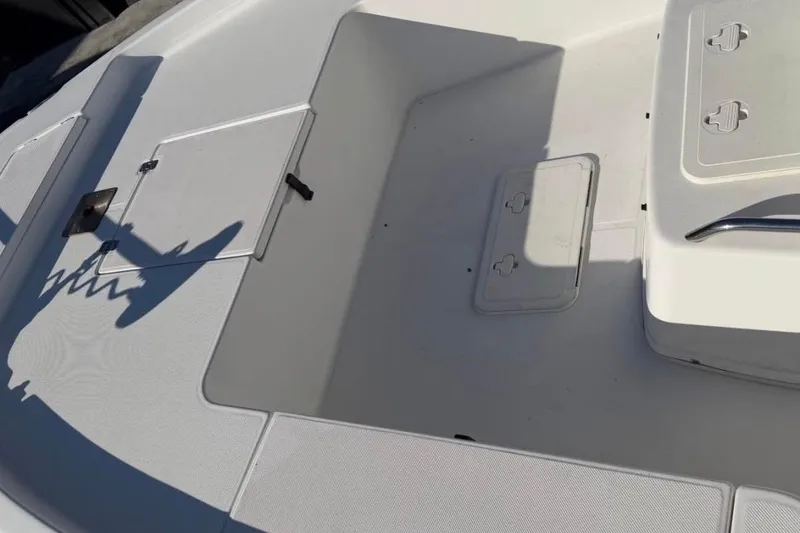 Slide: The Image of 2007 Century 2102 Inshore boat deck with storage compartments and shadow. - 6