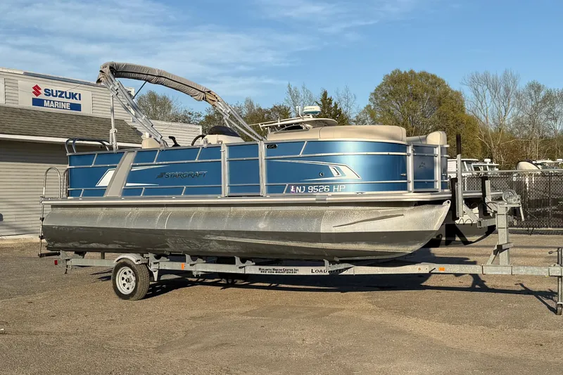 The Image of 2018 Starcraft EX 22 C SG pontoon boat on trailer at Suzuki Marine dealership. - 0