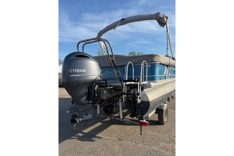 Slide: The Image of 2018 Starcraft EX 22 C SG pontoon boat with Yamaha outboard motor on trailer. - 14