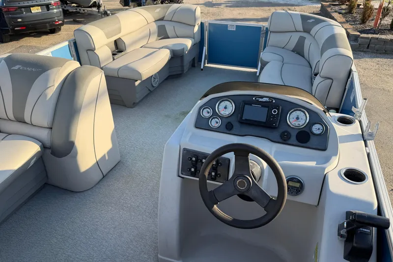 Slide: The Image of 2018 Starcraft EX 22 C SG pontoon boat interior with steering console and cushioned seating. - 17