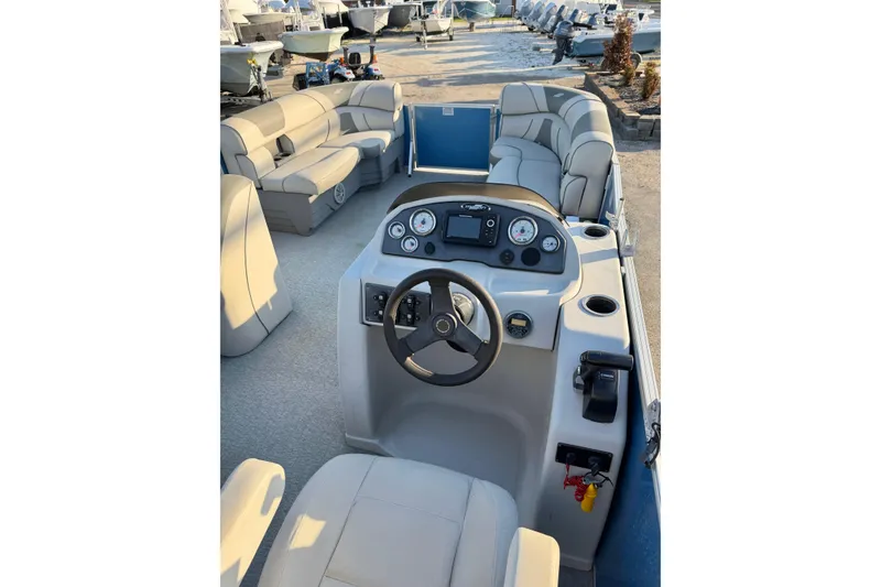 Slide: The Image of 2018 Starcraft EX 22 C SG pontoon boat interior with steering console and seating. - 19