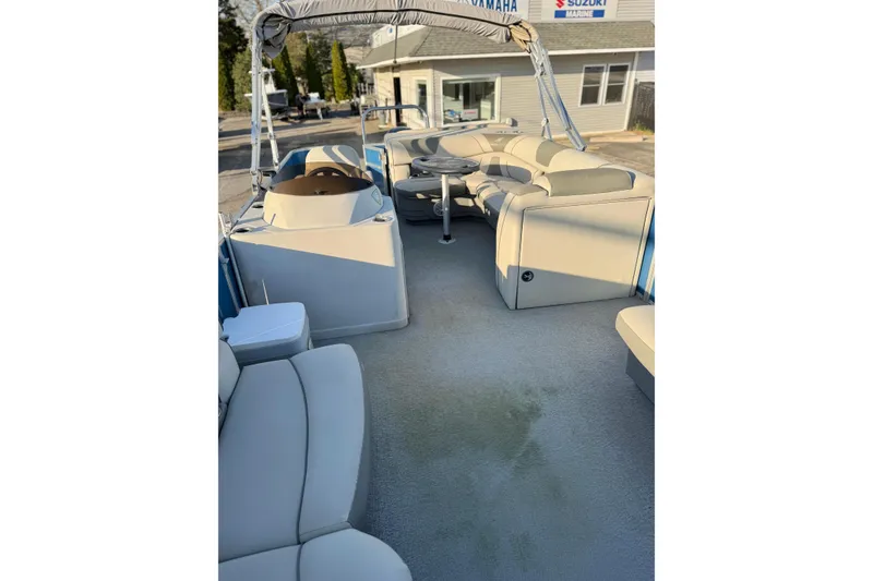 Slide: The Image of 2018 Starcraft EX 22 C SG pontoon boat interior with plush seating and helm. - 21