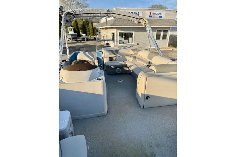 Slide: The Image of 2018 Starcraft EX 22 C SG pontoon boat with beige seating and canopy. - 23