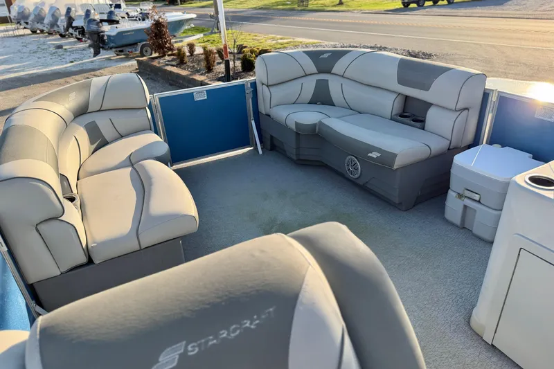 Slide: The Image of 2018 Starcraft EX 22 C SG pontoon boat interior with plush seating and cup holders. - 24