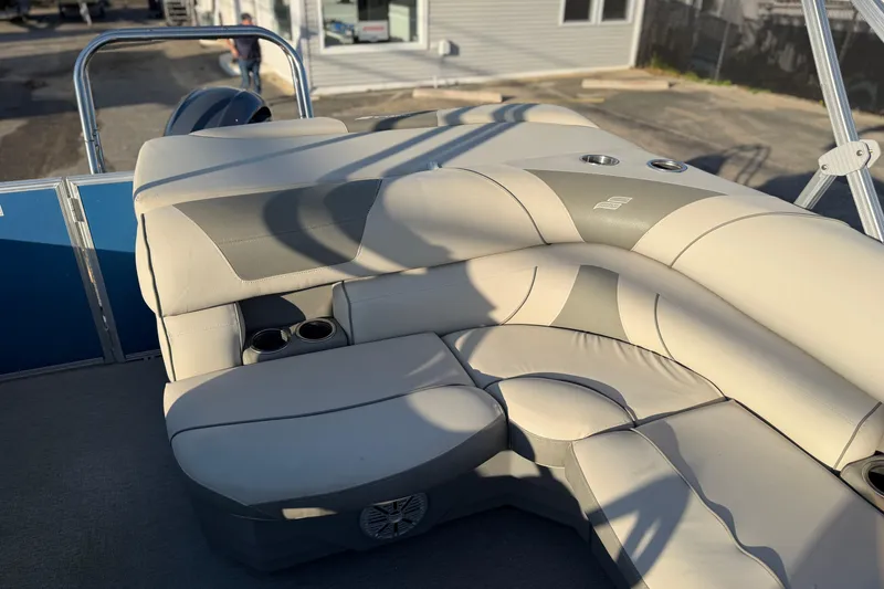 Slide: The Image of 2018 Starcraft EX 22 C SG boat interior with beige seating and cup holders. - 25