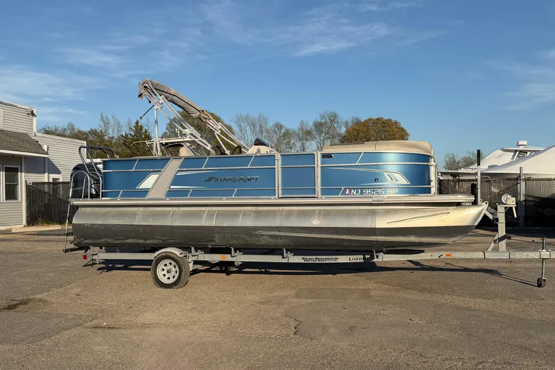 Slide: The Image of 2018 Starcraft EX 22 C SG pontoon boat on trailer in parking lot. - 3