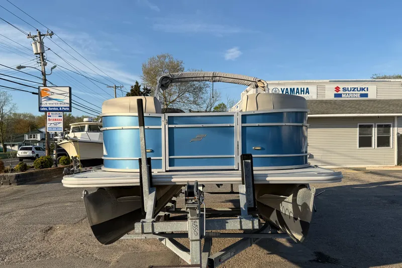 Slide: The Image of 2018 Starcraft EX 22 C SG pontoon boat on trailer at dealership, sunny day. - 6