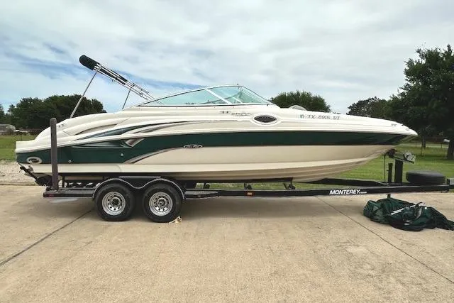 The Image of 2004 Sea Ray 270 Sundeck boat on trailer, parked outdoors. - 1