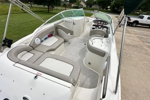 Slide: The Image of 2004 Sea Ray 270 Sundeck boat interior with seating and control panel. - 10