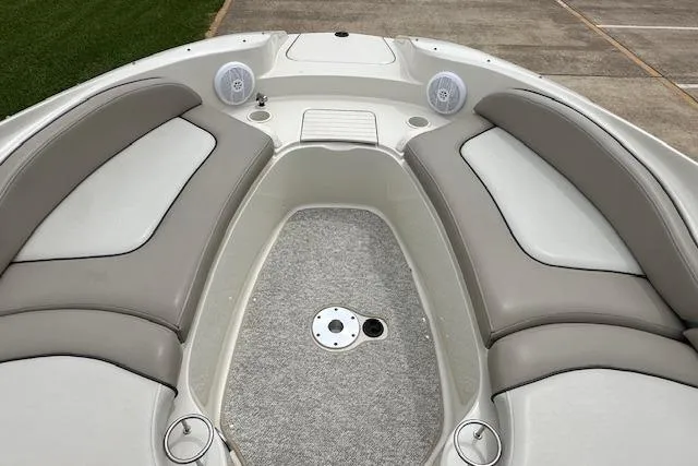 Slide: The Image of 2004 Sea Ray 270 Sundeck boat interior with cushioned seating and speakers. - 14