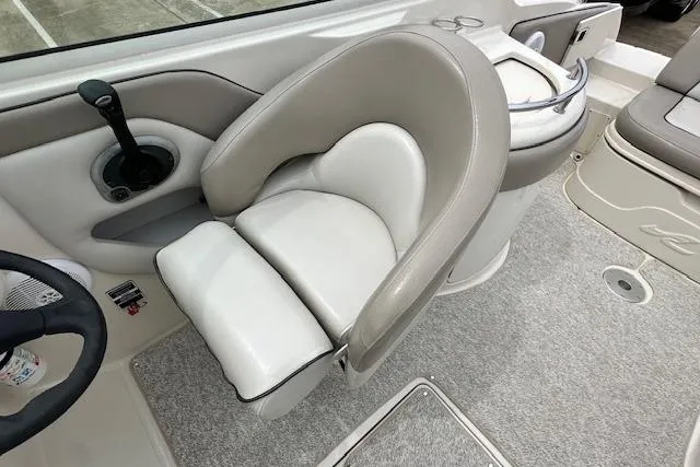Slide: The Image of Captain's seat on 2004 Sea Ray 270 Sundeck boat, featuring beige and white upholstery. - 16