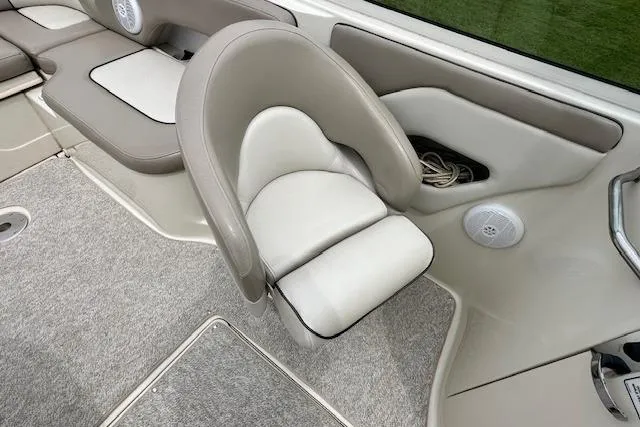 Slide: The Image of 2004 Sea Ray 270 Sundeck interior with beige seating and carpeted flooring. - 17
