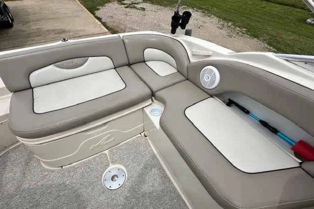 Slide: The Image of 2004 Sea Ray 270 Sundeck interior with beige seating and built-in speaker. - 18