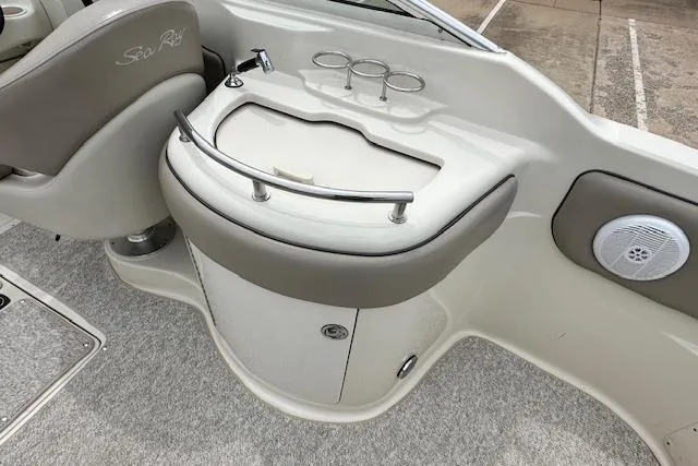 Slide: The Image of Interior view of a 2004 Sea Ray 270 Sundeck boat, featuring a compact sink and seating area. - 19