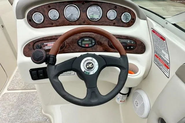 Slide: The Image of Steering console of a 2004 Sea Ray 270 Sundeck boat with wood accents and gauges. - 20