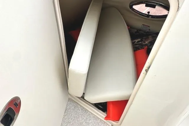 Slide: The Image of Storage compartment in a 2004 Sea Ray 270 Sundeck boat with cushions and life jackets. - 24