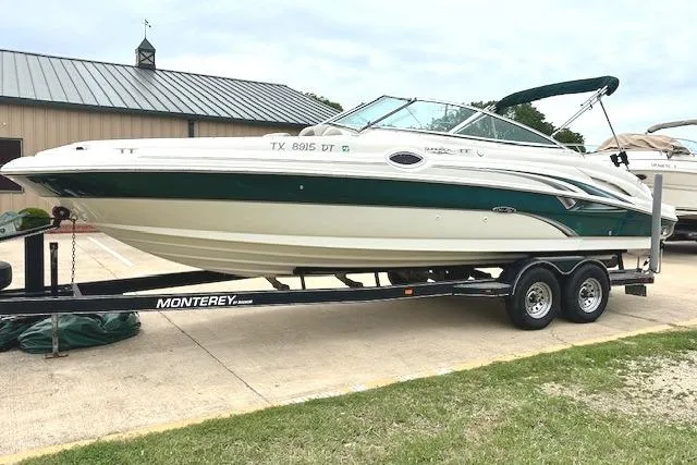 Slide: The Image of 2004 Sea Ray 270 Sundeck boat on trailer, parked outdoors. - 3