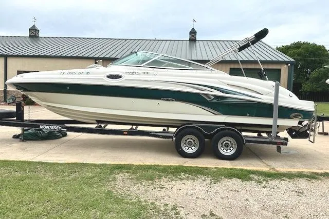 Slide: The Image of 2004 Sea Ray 270 Sundeck boat on trailer, parked outdoors. - 4