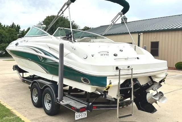 Slide: The Image of 2004 Sea Ray 270 Sundeck boat on trailer, parked outdoors. - 5